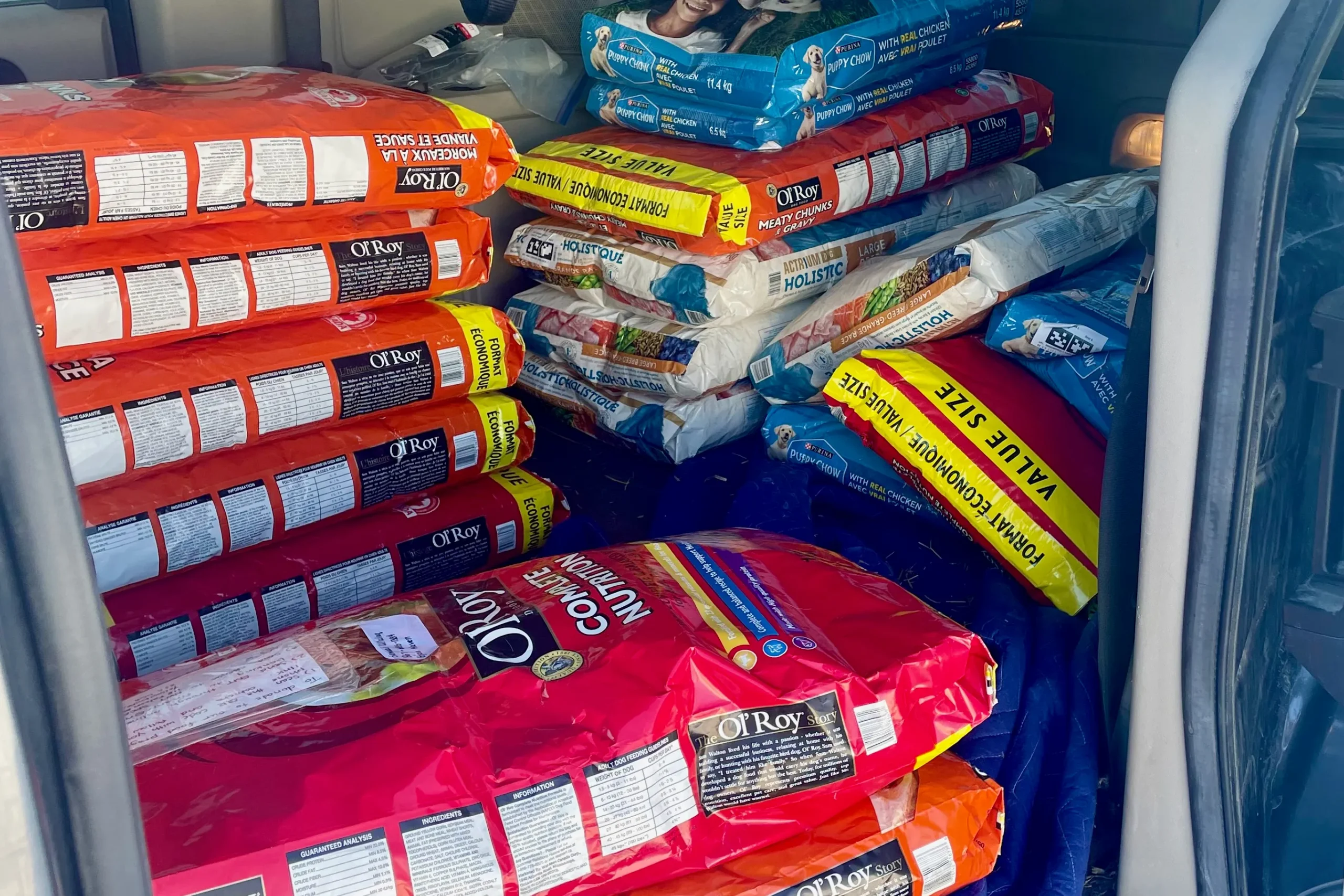 the back of a van full of packs of dog food